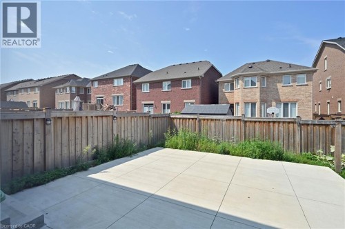Expansive concrete patio with a full privacy fence - 64 Maple Cider Street, Caledon, ON 