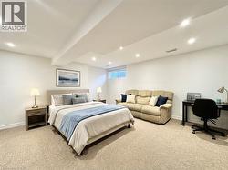 Staged with AI. Basement can be easily used as a bedroom. It comes with the half washroom as well. - 