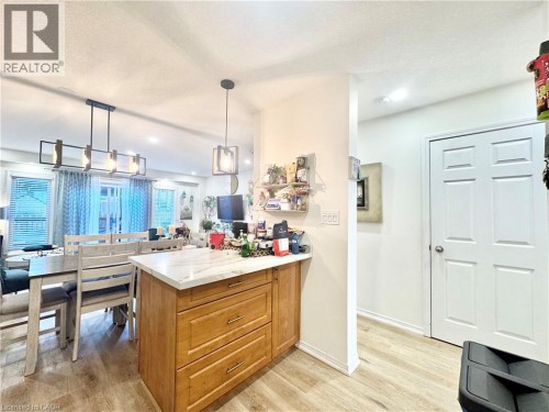 Central kitchen island with a light-toned countertop - 1335 Countrystone Drive, Kitchener, ON 