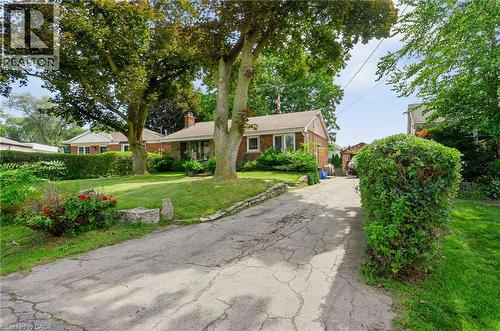 Brick exterior, expansive front lawn, mature trees, established landscaping, paved driveway - 1046 Shepherds Drive, Burlington, ON 