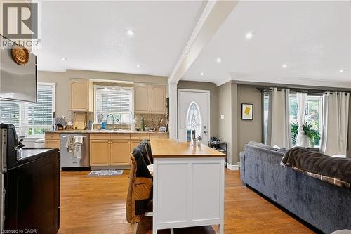 Kitchen with tan cabinetry, tile backsplash, and stainless steel appliances - 1046 Shepherds Drive, Burlington, ON 