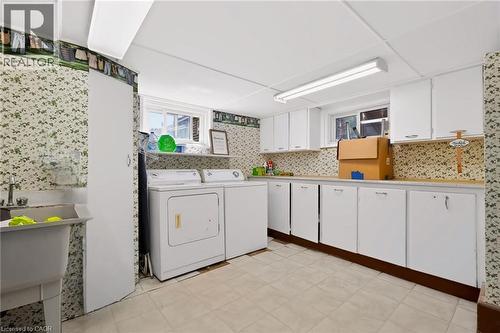 Built-in cabinetry, utility sink, overhead lighting, and window - 1046 Shepherds Drive, Burlington, ON 