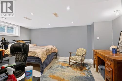 Recessed ceiling lighting, white ceiling, window with white trim, light gray walls, and light-toned tile flooring - 1046 Shepherds Drive, Burlington, ON 