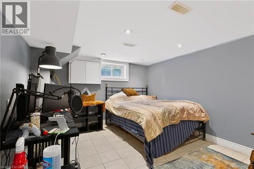Recessed lighting illuminates the space, featuring tile flooring and a window - 1046 Shepherds Drive, Burlington, ON 