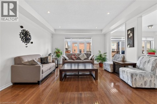 Living area with hardwood / wood-style floors and a tray ceiling - 97 Sirente Drive, Hamilton, ON 