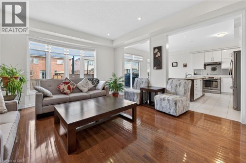 Living area featuring light wood finished floors and recessed lighting - 97 Sirente Drive, Hamilton, ON 