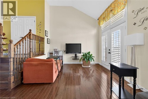 Living area with lofted ceiling and dark wood-style flooring - 97 Sirente Drive, Hamilton, ON 