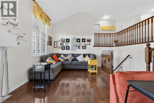 Living area featuring wood-type flooring and vaulted ceiling - 97 Sirente Drive, Hamilton, ON 