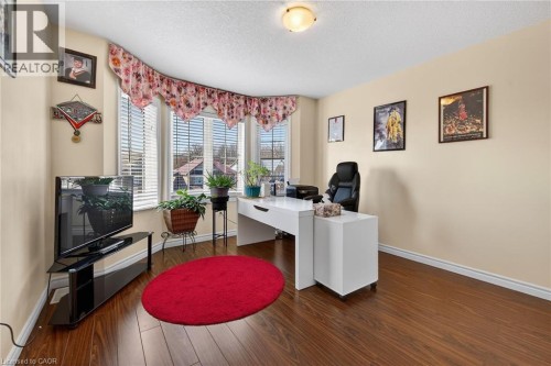 Office space with dark wood finished floors and a textured ceiling - 97 Sirente Drive, Hamilton, ON 