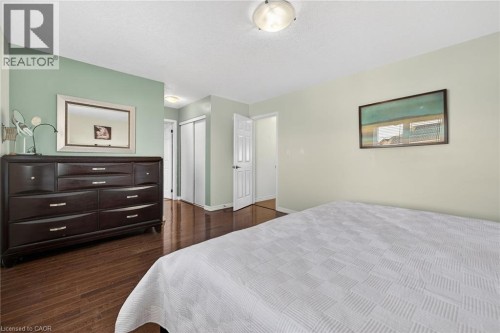 Bedroom featuring dark wood-style floors and a closet - 97 Sirente Drive, Hamilton, ON 