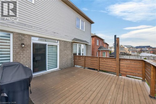 Wooden terrace featuring grilling area and a residential view - 97 Sirente Drive, Hamilton, ON 