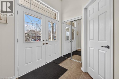 Entrance foyer featuring light tile patterned floors and baseboards - 97 Sirente Drive, Hamilton, ON 
