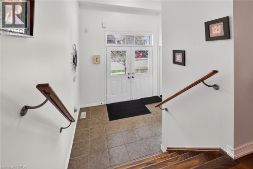 Foyer entrance featuring french doors and tile patterned floors - 97 Sirente Drive, Hamilton, ON 
