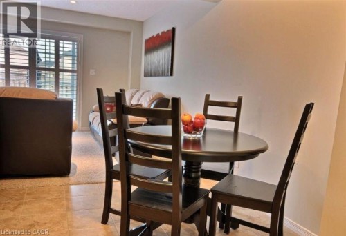 Tiled flooring in dining area, recessed lighting, and patio doors with shutters - 507 Beaumont Crescent, Kitchener, ON 