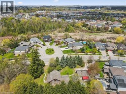 Residential neighborhood featuring mature trees, cul-de-sac street design, and private swimming pools - 