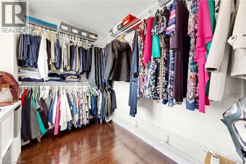 Custom closet system featuring multiple hanging rods and shelving - 173 Raymond Road, Ancaster, ON 