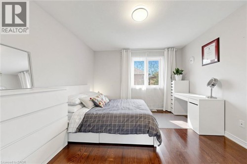 Wood-finish flooring, white walls, and a ceiling-mounted light fixture - 173 Raymond Road, Ancaster, ON 