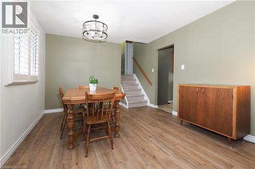 Wood-finish flooring, plantation shutters, and a modern ceiling fixture - 219 Foxhunt Road, Waterloo, ON 