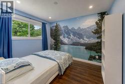 Expansive window, recessed lighting, and wood-finish flooring - 