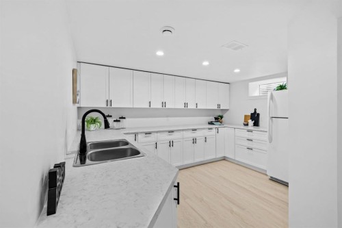 Basement kitchen with full fridge (tons of cabinets) - 804 Polson Avenue, Winnipeg, MB 