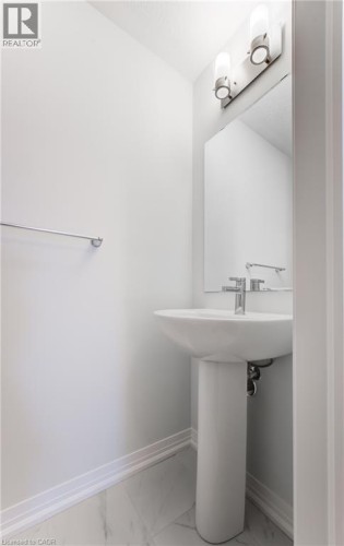Pedestal sink with chrome fixtures and wall-mounted lighting - 25 Urbane Boulevard, Kitchener, ON 