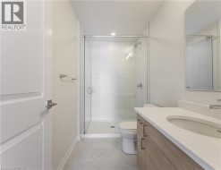 Walk-in shower with clear glass enclosure and tile surround - 