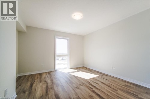 Wood-finish flooring, white walls, single window, and a ceiling-mounted light fixture - 25 Urbane Boulevard, Kitchener, ON 