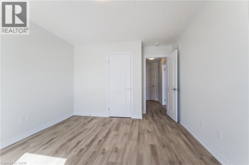 Light-toned wood-finish flooring, white walls, and bright overhead lighting - 25 Urbane Boulevard, Kitchener, ON 
