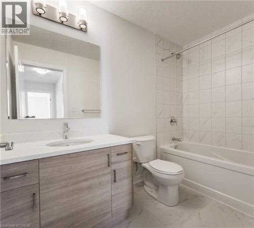 Wood-finish vanity with a white countertop and undermount sink - 25 Urbane Boulevard, Kitchener, ON 