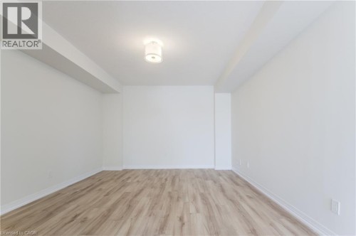 Recessed ceiling beam, wood-finish flooring, white walls, flush mount ceiling light - 25 Urbane Boulevard, Kitchener, ON 