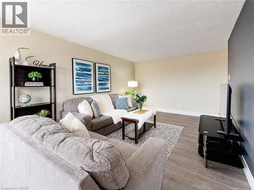 Wood-finish flooring with neutral wall tones - 4 Avalon Place Unit# 303, Kitchener, ON 