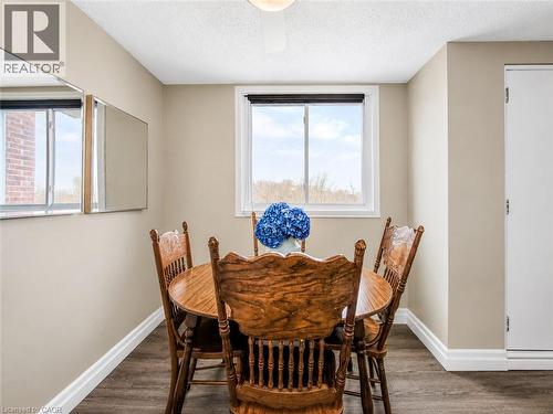 Interior space featuring wood-finish flooring, a white trim package, and light-toned wall paint - 4 Avalon Place Unit# 303, Kitchener, ON 