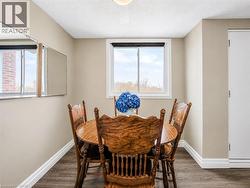Interior space featuring wood-finish flooring, a white trim package, and light-toned wall paint - 