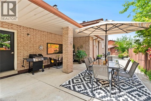 Covered patio featuring brick exterior walls and a concrete surface - 87 Monte Drive, Hamilton, ON 