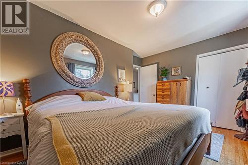 Wood-finish flooring with a neutral area rug - 648-654 Francis Road, Burlington, ON 