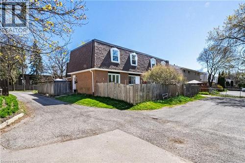 Brick exterior with a dark gambrel roof - 648-654 Francis Road, Burlington, ON 
