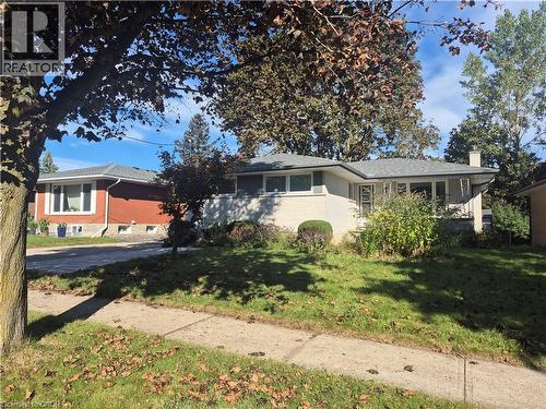 White brick exterior with a gray shingle roof - 11 Duncairn Avenue, Kitchener, ON 