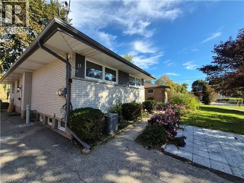 Light-colored brick exterior with dark trim and gutters - 11 Duncairn Avenue, Kitchener, ON 