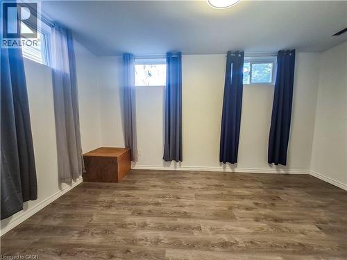 Recessed windows with natural light, wood-finish flooring, and white painted walls - 11 Duncairn Avenue, Kitchener, ON 