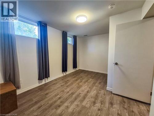 Wood-finish flooring, white walls, and multiple windows - 11 Duncairn Avenue, Kitchener, ON 
