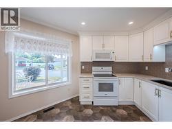 Kitchen with quartz countertops & tile backsplash - 
