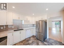 Kitchen with quartz countertops & new fridge - 