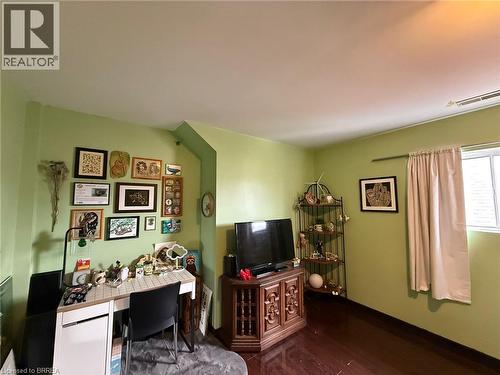 Dark wood-finish flooring with light green wall color - 12 Bridgeport Road E Unit# 18, Waterloo, ON 