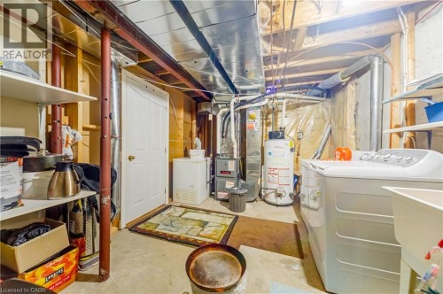 Full-size laundry area with utility sink, water heater, and furnace - 82 Milner Downs Crescent, Ottawa, ON 
