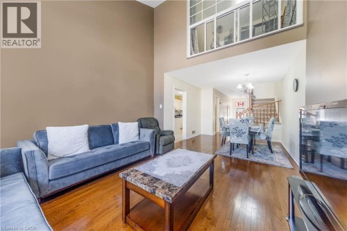 Expansive living area featuring soaring ceilings and wood-finish flooring - 82 Milner Downs Crescent, Ottawa, ON 