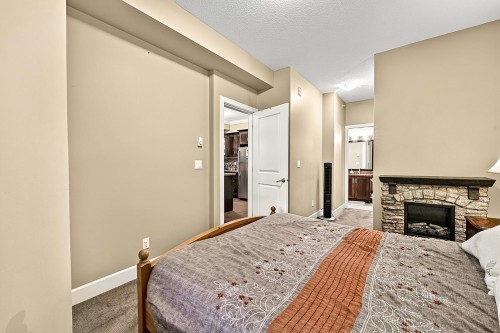 411-13897 Fraser Highway, Surrey, BC - Indoor Photo Showing Bedroom With Fireplace