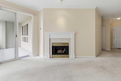 226-3098 Guildford Way, Coquitlam, BC - Indoor Photo Showing Other Room With Fireplace