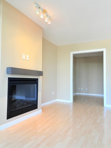 602-4333 Central Boulevard, Burnaby, BC - Indoor Photo Showing Other Room With Fireplace