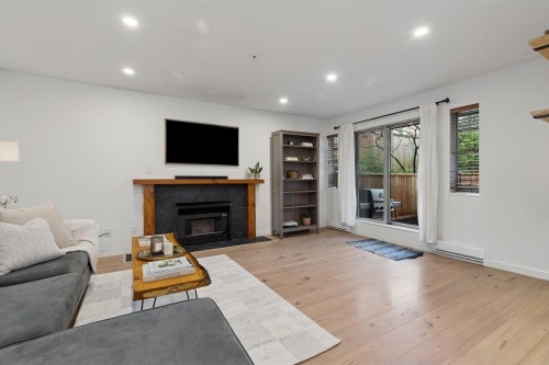 102-1689 4Th Avenue E, Vancouver, BC - Indoor Photo Showing Living Room With Fireplace