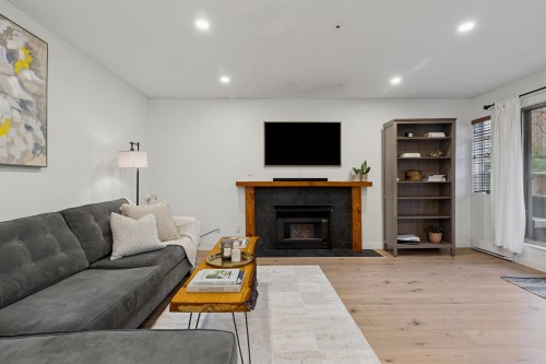 102-1689 4Th Avenue E, Vancouver, BC - Indoor Photo Showing Living Room With Fireplace
